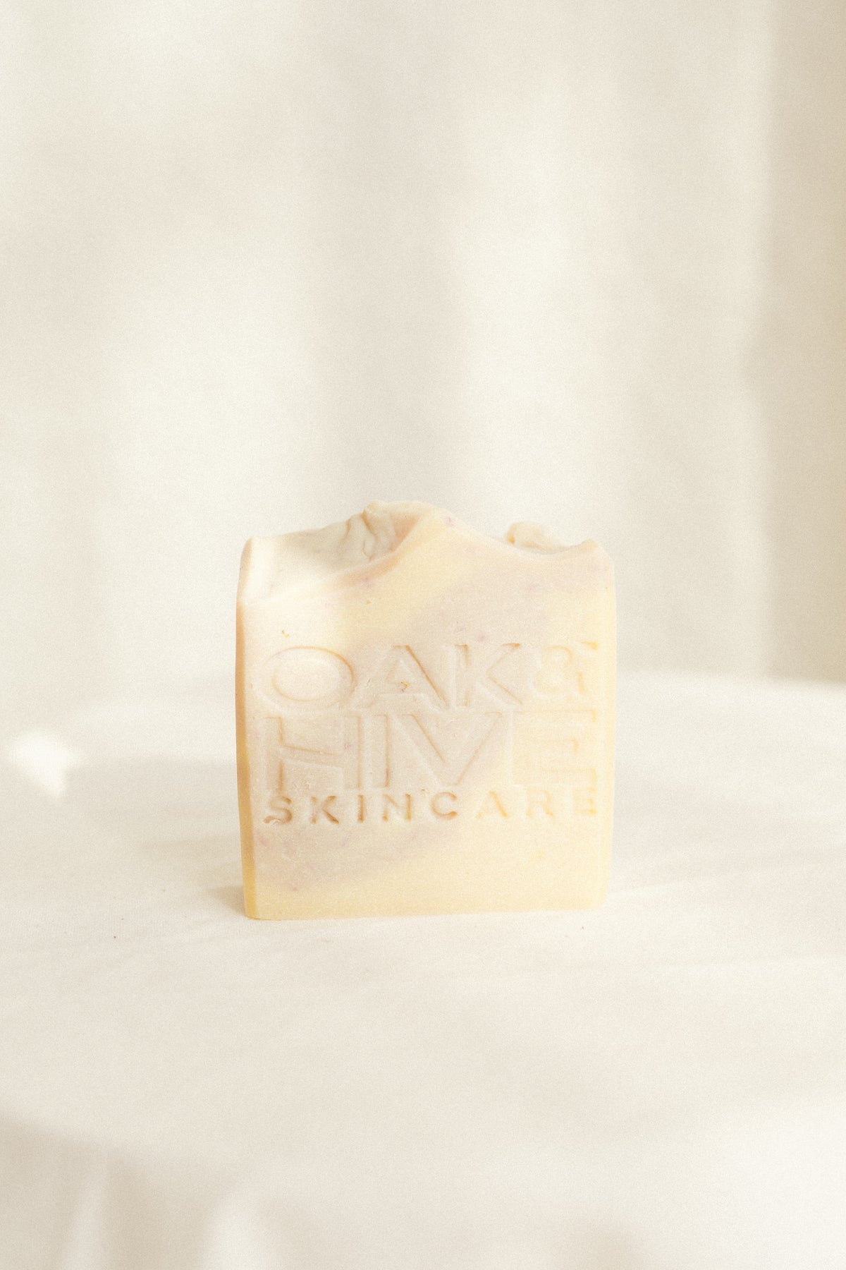 a purple and white swirl soap with a white background