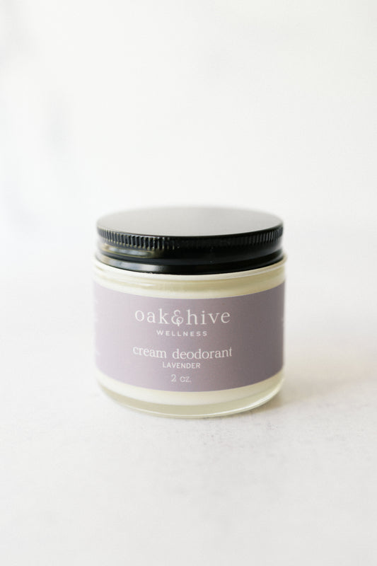 a jar of lavender deodorant with a purple label, a black lid on a white background.