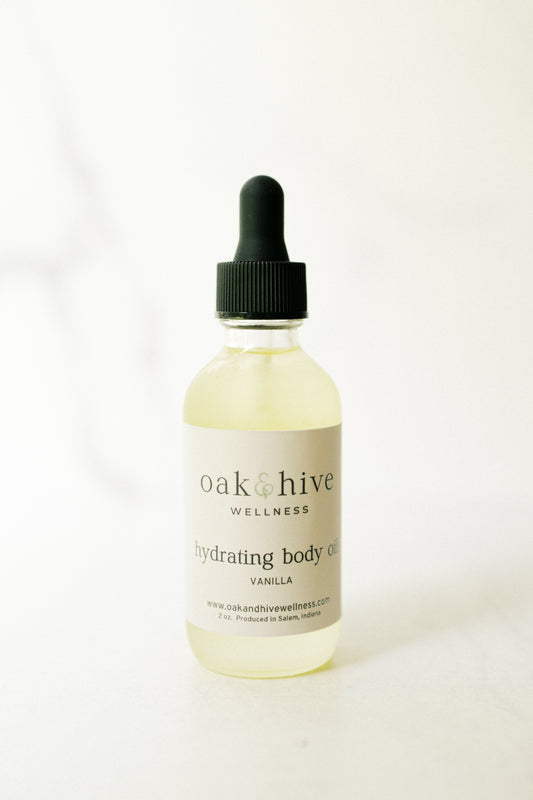 Bottle of oak & hive wellness body oil vanilla on a white background