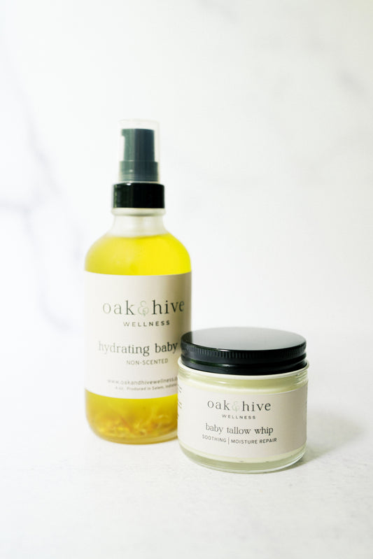 Two products, one being a bottle of oil, and the other being a jar from Oak & Hive Wellness on a white background