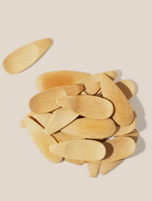 Stack of wooden spoons on a beige background