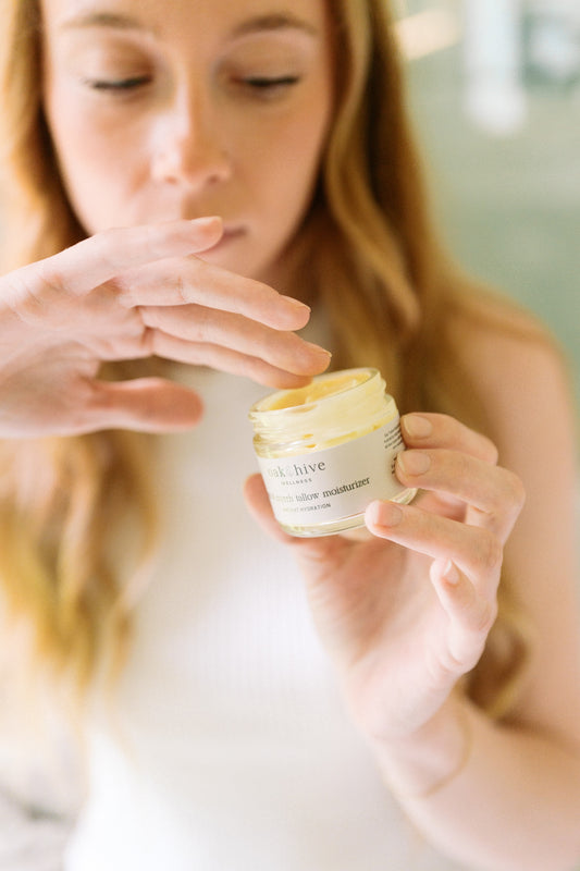 Woman holding a jar of cream with a blurred background