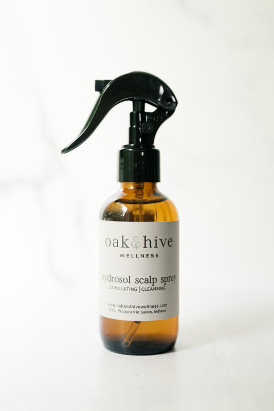 Bottle of oak & hive wellness hydrosol scalp spray on a white background