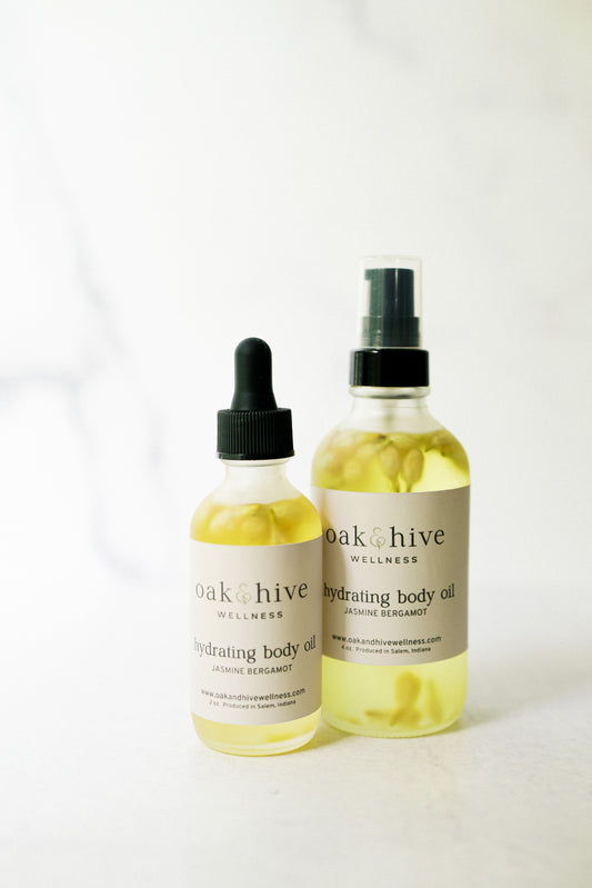 Two bottles of 'oak & hive' jasmine bergamot body oil on a white background