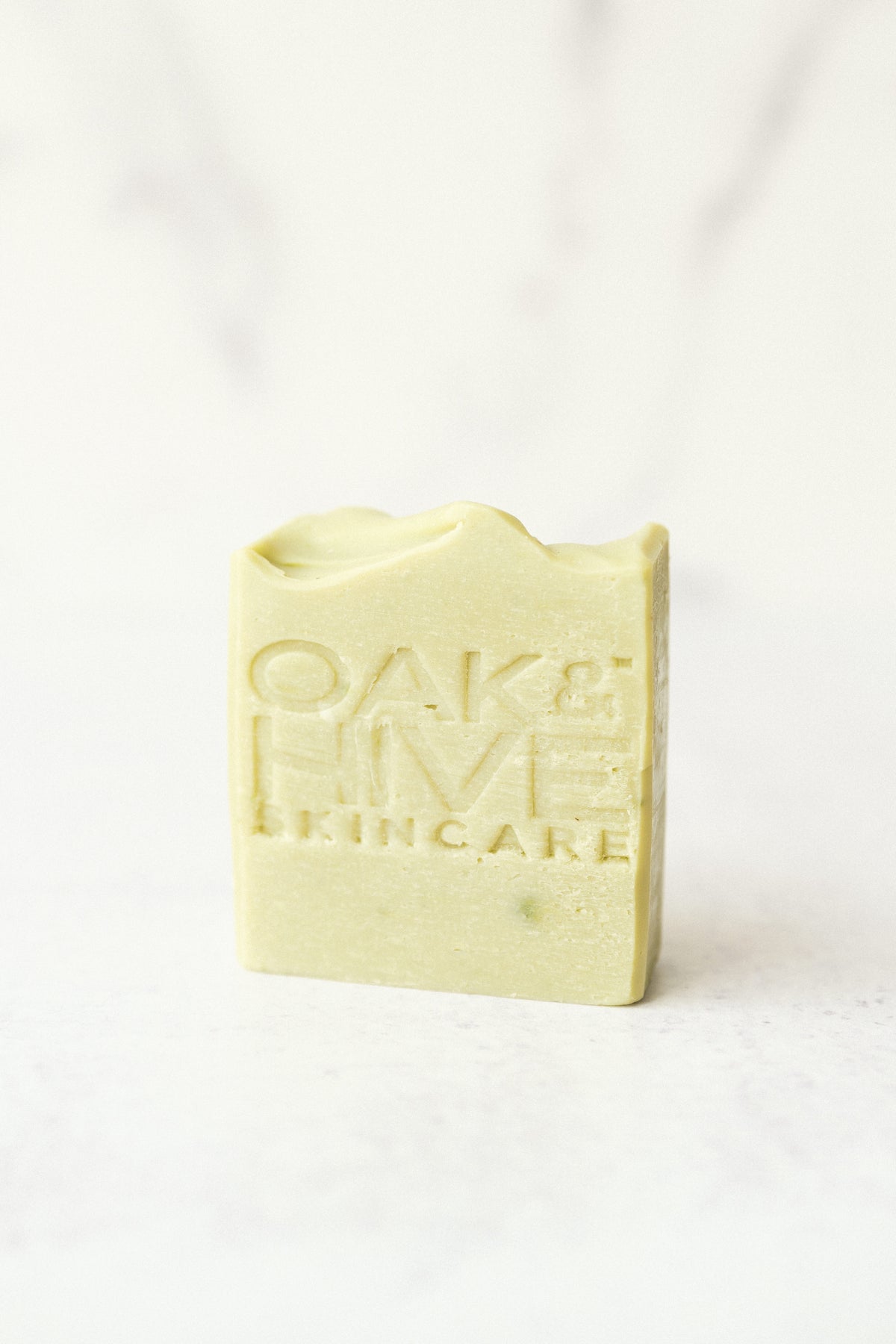 a green bar of soap on a white background 
