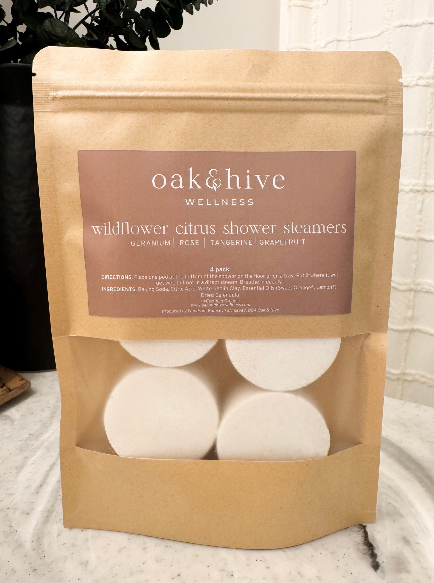 Package of oak & hive wildflower citrus shower steamers on a neutral background